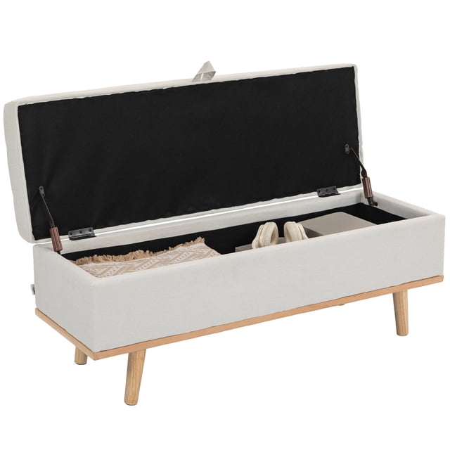 HOMCOM Ottoman de Rangement en Blanc Crème avec Couvercle Relevable, Doté d'Un Spacieux Compartiment de Rangement Caché. l'Ottoman Est Rembourré en Tissu Respirant Aspect Lin avec Rembourrage en Mousse Haute Densité pour le Confort. Il a un Cadre en Bois Massif et des Pattes en Bois Inclinées avec des Coussinets en Feutre pour Protéger les Planchers. le Couvercle Ouvert Révèle l'Espace de Rangement Contenant une Couverture, des Écouteurs et des Livres, Mettant en Valeur Son Utilisation Multifonctionnelle comme Repose-Pieds, Siège Supplémentaire Ou Banc de Bout de Lit. Dimensions : 46,5 Pouces de Large, 16,5 Pouces