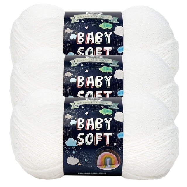 Lion Brand Baby Soft Yarn three skeins of white medium sportweight acrylic nylon yarn with labels featuring pastel clouds and a rainbow, ideal for knitting soft, durable baby items and crafts.