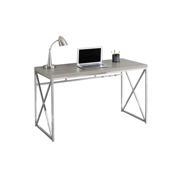 Monarch Specialties Computer Desk with a brown reclaimed wood-look laminate top and chrome criss-cross metal legs, designed for home office and laptop work, shown with a silver desk lamp, laptop, and pencil holder on the surface.