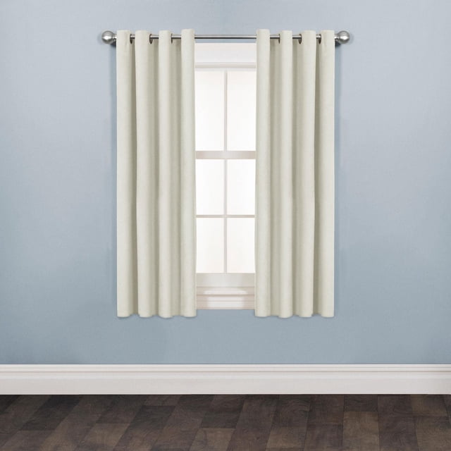 Mainstays Faux Suede Drapery Grommet Window Curtains Panel in off-white hanging on a silver metal rod over a window with grid panes, set against a light blue wall and dark wood floor, featuring soft-touch faux suede texture, matte finish, and easy-install grommet rings, ideal for room darkening and decor refresh.