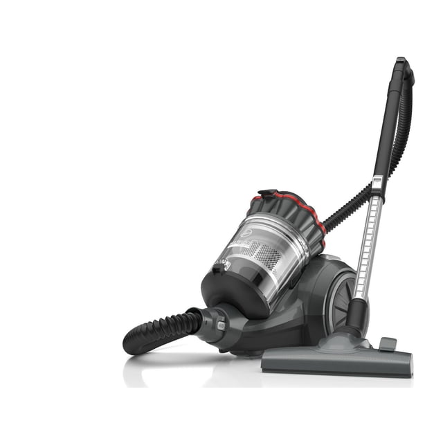 Hoover Aspirateur-traîneau Sans Sac MultiFloor en Vue Profil 3/4 avec Corps Gris Foncé, Bac à Poussière transparent avec Garniture Rouge, Boyau flexible et Buse de Plancher Multisurface. Il Présente un Système Multi-Cyclonique Avancé et un Enroulement Automatique du Cordon pour un Nettoyage Efficace des Planchers Durs et des Tapis à Poils Courts.
