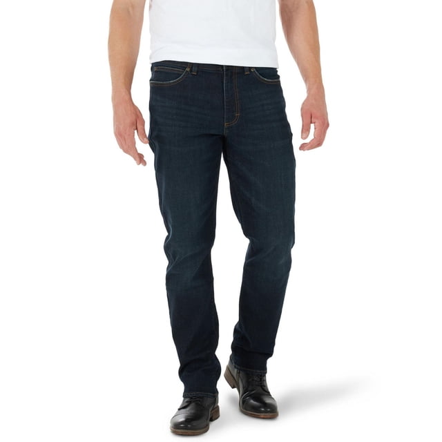 Lee Men's Athletic Taper Jean in dark indigo denim shown front-facing on a male model wearing black dress shoes and a white shirt, featuring a mid-rise waist, athletic fit with tapered legs and 15 1/2 inch leg openings, zip-fly with button closure, and two back pockets without closures, made with flexible performance stretch fabric for comfort and movement, also suitable for casual or active wear.