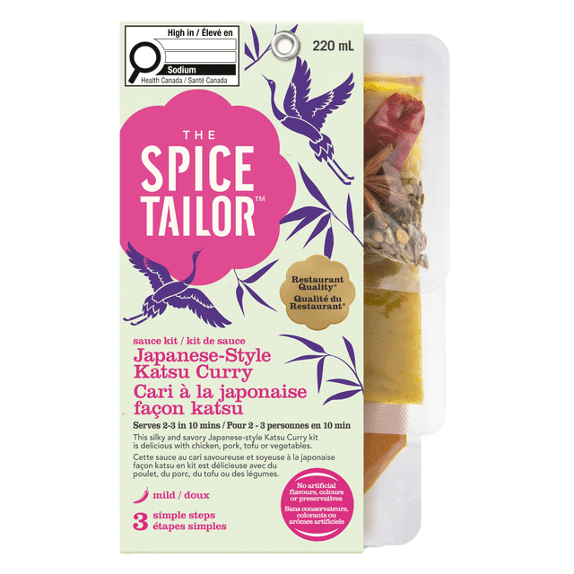 The Spice Tailor Japanese Katsu sauce kit in a 220 mL package with purple crane and bamboo illustrations on a light background, labeled restaurant quality and mild, featuring three simple steps to prepare Japanese-style katsu curry sauce without artificial flavours, suitable for chicken, pork, tofu, or vegetables.