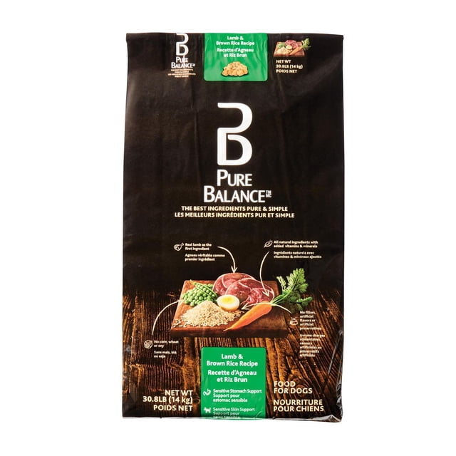 Pure Balance Lamb & Brown Rice Recipe Dry Dog Food 30.8 lb (14 kg) bag with black packaging featuring images of lamb meat, brown rice, peas, carrot, and egg on a wooden board, highlighting real lamb as the first ingredient, no corn, wheat, or soy, natural vitamins and minerals, and support for sensitive stomach and skin health.