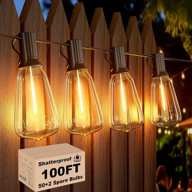 Svater Outdoor String Lights 100ft ST38 Patio String Lights with 52 warm white waterproof, shatterproof, and energy-efficient LED bulbs, mounted on a wooden fence. The vintage-style connectable lights emit a warm glow, perfect for outdoor spaces like backyards, gardens, and porches. Includes a box labeled 'Shatterproof 100FT 50+2 Spare Bulbs.'