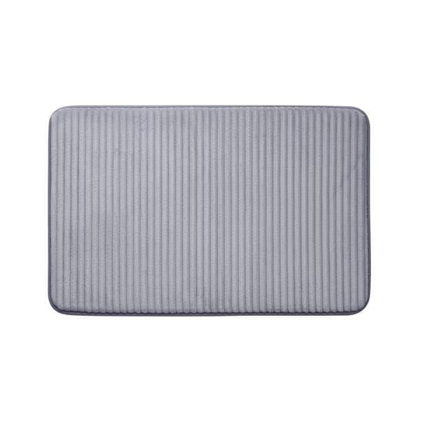 Mainstays Memory Foam Bath Mat in light grey with ribbed texture, measuring 20 by 30 inches, featuring cushioned memory foam and non-slip backing, soft and absorbent bathroom rug suitable for stepping out of the shower or standing at the sink.