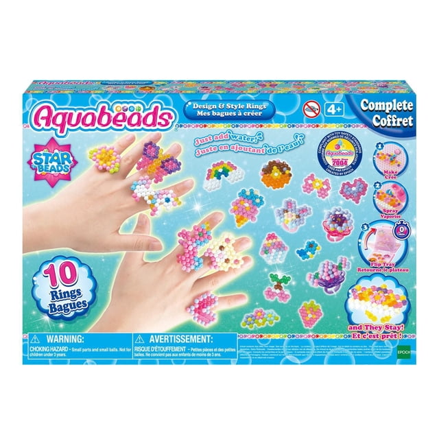 Aquabeads Design & Style Rings complete arts and crafts bead kit for children featuring over 1,000 solid, jewel, and star-shaped beads in 20 vibrant colors, including 10 ring bases, templates, sprayer, and layout tray for creating water-activated bead designs shown on hands and as colorful patterns on a blue background, suitable for kids aged 4 and up.