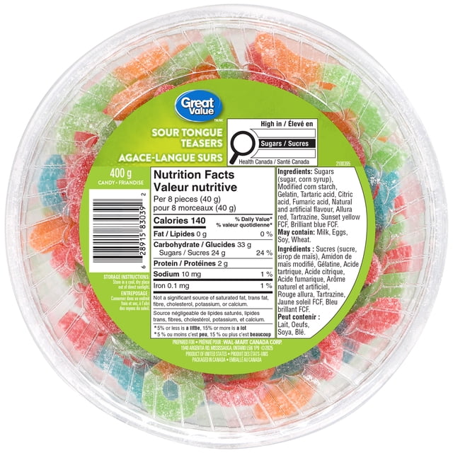 Great Value Sour Tongue Teasers in a clear round plastic tub filled with multicoloured sour gummy candies shaped like tongues in red, green, blue, and orange, featuring a green label with nutrition facts and ingredients in English and French, ideal for snacking and dessert toppings.