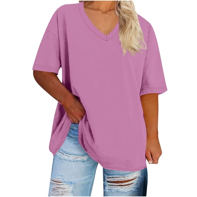 FAIWAD Womens Tops Summer Plus Size Casual V Neck Short Sleeve Drop Shoulder T-Shirt in a loose, comfy design. The women's t-shirt is shown in a solid pink color with a relaxed fit, featuring a V-neckline and short sleeves. Paired with distressed light blue jeans, the outfit is styled casually, ideal for summer outings or casual wear.