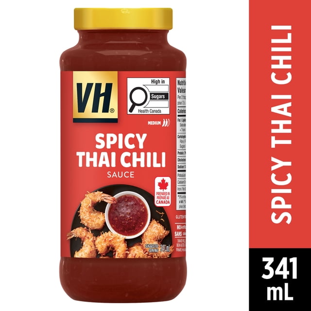 Sauce Trempette au Chili Thaï Épicée Sans Gluten VH dans un Pot Transparent de 341 ml avec Couvercle Jaune, Étiquette Rouge Mettant en Vedette le logo VH, Avertissement de Santé Canada sur le Sucre, et Crevettes Frites avec image de Bol de Sauce au Chili, Piquant Moyen, Préparée au Canada, Convient pour Tremper Ou Mariner Divers Plats.