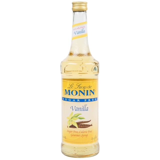 Monin Sirop Aromatisant à la Vanille Sans Sucre de 750 ml dans une Bouteille en Verre Élégante avec une Étiquette Jaune Mettant en Vedette le logo Monin et l'Image de Vanille. Ce Sirop Offre une Saveur de Vanille Sucrée et Façon Crème Anglaise, Idéale pour Rehausser le Café, les Lattés et les cocktails Sans Sucre Ni calories Ajoutés. Compatible avec une Pompe à Sirop Monin de 0,25 oz (Vendue Séparément) pour une Distribution Précise. Convient aux Régimes Véganes et Sans Produits Laitiers, Il