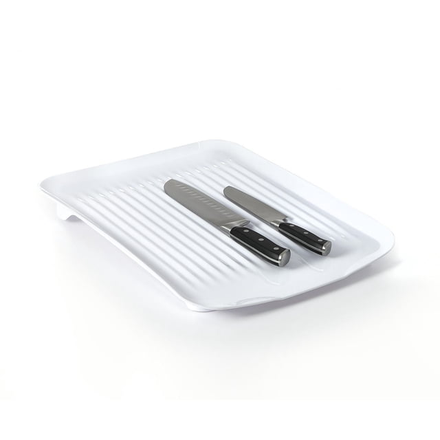 Maison Kleen Dish Drain Board in white with raised edges and sloped ribbed surface holding two black-handled kitchen knives, designed to drain water back into the sink and keep counters dry, also suitable for use under a dish rack for kitchen sink organization.