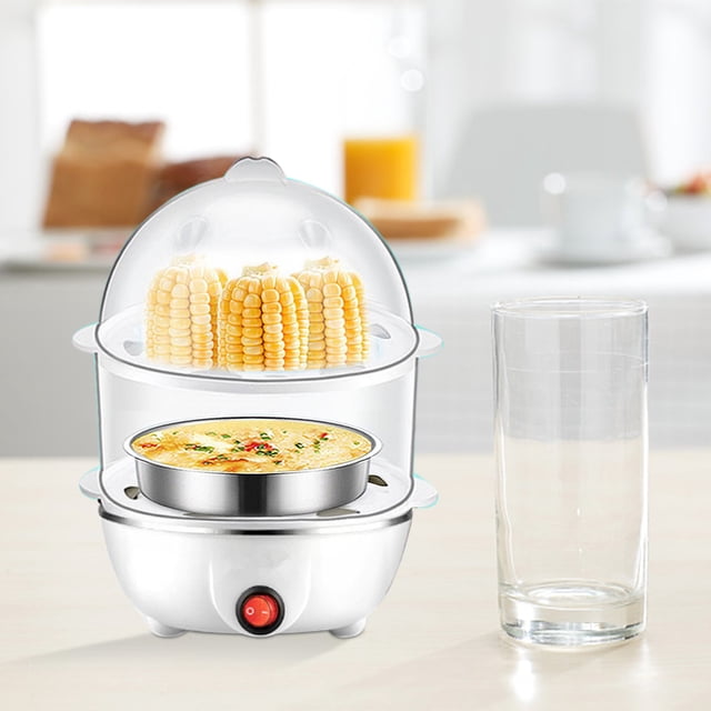 Holiday Gifts, Kitchen Gadgets, Multifunctional Eggs Cooker with double-layer design and European standard. A compact white egg cooker with a transparent lid is shown steaming corn on the upper layer and a dish of steamed eggs on the lower layer. The cooker features a red power button and is placed on a kitchen countertop with a glass and breakfast items in the background. Suitable for steaming various foods like corn, buns, and baby meals, making it a versatile small appliance for home kitchens.
