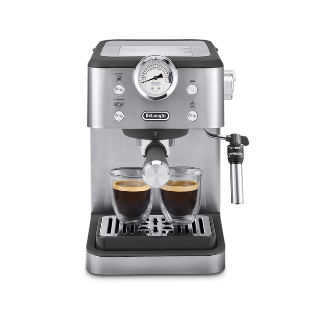 De’Longhi Classic Espresso Machine with stainless steel finish, front chrome pressure gauge, dual espresso spouts brewing two shots into clear glass cups, and adjustable steam wand for hot milk and cappuccino frothing, on a drip tray with removable water tank at the back.