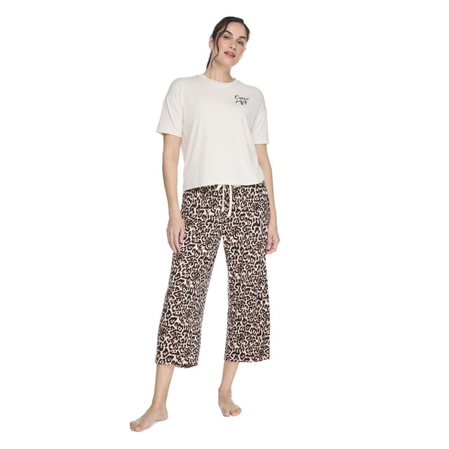 George women's two piece capri pajama set with a cream crew neck short sleeve T-shirt featuring a small black graphic on the left chest, paired with leopard print capri pants with an elasticized waistband and drawstring, shown in a front-facing full body view on a white background, ideal for relaxed evenings or comfortable loungewear.