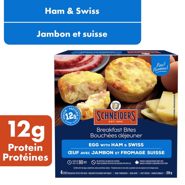 Schneiders Ham & Swiss Egg Breakfast Bites pack showing two fluffy egg bites with diced ham and Swiss cheese on a wooden surface, accompanied by sliced ham and Swiss cheese, highlighting 12g protein per serving and 90-second microwave readiness.