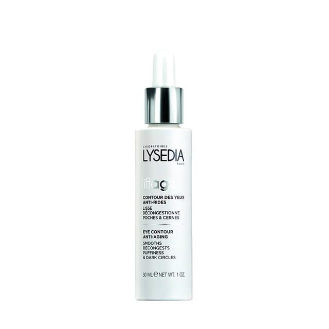 Lysedia Liftage Contour des Yeux Anti-âge Bouteille de 30 ml avec un design Blanc Épuré et un Bouchon Argenté. Cette Crème pour les Yeux anti-fatigue Est Formulée pour Tous les types de Peau, Ciblant les Poches, les Cernes et les Ridules. Enrichie d'Extrait de Lotus Bleu et de Camomille, Elle Hydrate, Lisse et Illumine la Zone du Contour des Yeux pour une Apparence Jeune.