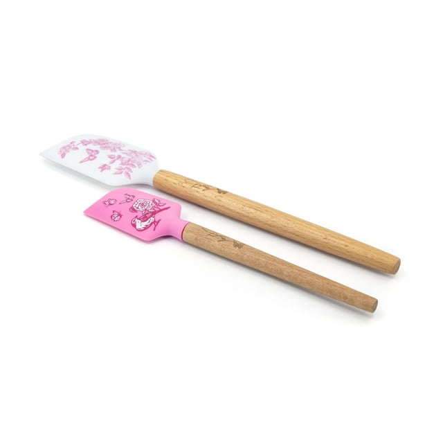 Dolly Parton 2-Pack Silicone Spatula Set with two wooden-handled spatulas featuring heat-resistant silicone heads; one white with pink floral and butterfly prints, the other pink with bird and rose designs, safe for nonstick cookware and ideal for mixing and scraping ingredients.
