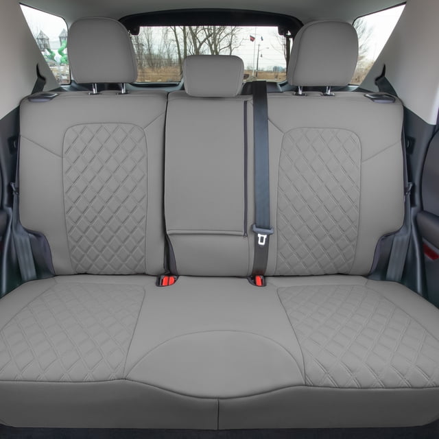 For 2021-2024 Ford Bronco Sport FH Group Neoprene Custom Fit Seat Covers in solid gray, designed for the rear seat. The set includes one rear bench seat cover and three separate headrest covers. Made from durable neoprene with Neosupreme trim, the material is water-resistant, lightweight, and cushioned for added comfort. The precision-cut design ensures a tailored fit for Ford Bronco models. The image shows the seat covers installed on a rear bench seat with a diamond-patterned texture and a solid gray finish, highlighting the snug fit and clean design.