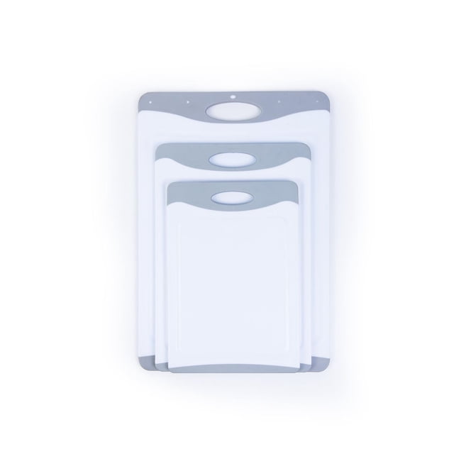 Mainstays 3PK POLY BOARDS 1.41 inch set with three nested white plastic cutting boards featuring gray handles and juice grooves, reversible surfaces for versatile food prep and dishwasher safe, also ideal for serving snacks.