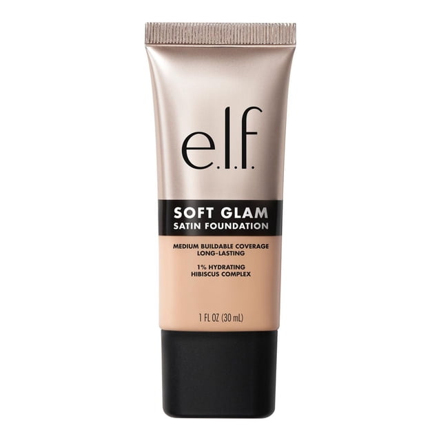 e.l.f. Cosmetics Soft Glam Satin Foundation in a 30 ml beige tube with a black cap, featuring medium buildable coverage and a satin finish. Infused with 1% Hydrating Hibiscus Complex, this breathable, long-lasting liquid foundation suits dry, oily, and combination skin for smooth, non-cakey wear.