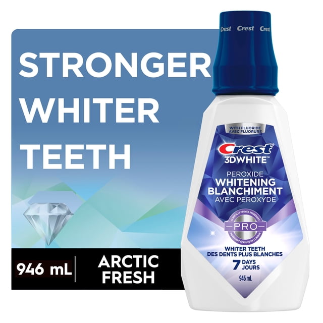 Crest 3D White Peroxide Mouthwash 946 mL bottle with dark blue cap and Arctic Fresh flavor, featuring fluoride and peroxide to whiten teeth in 7 days, strengthen enamel, prevent cavities, and provide alcohol-free fresh breath.