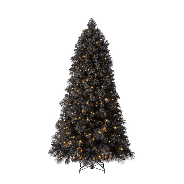 Home Heritage Snowdrift 6.5 Ft Pre-Lit Artificial Christmas Holiday Tree in black, featuring 777 lush foliage tips and 500 warm white LED lights. This artificial Christmas tree stands 78 inches tall and 44 inches wide, with a sturdy metal stand and foot pedal for light control. Perfect as a holiday centerpiece for indoor decor.