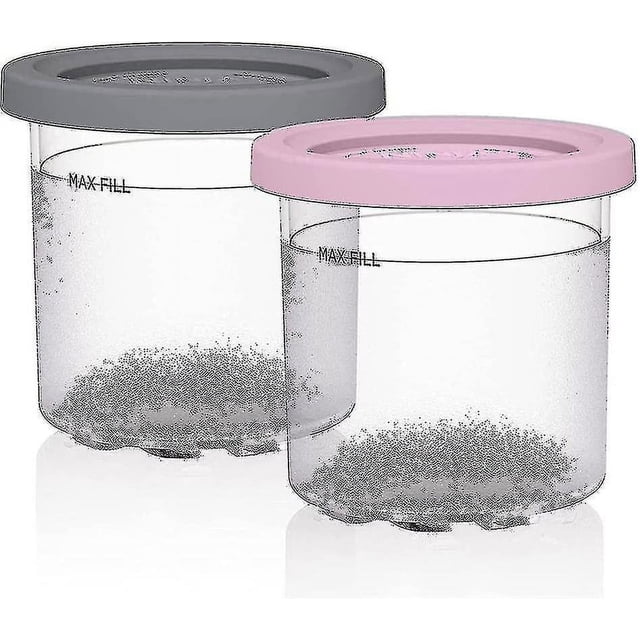 Ice Cream Pints Containers, replacement for Ninja Creami pints and lids, compatible with NC300, NC301, CN305A, NC299AM series. The image displays two reusable freezer storage containers made of durable, BPA-free plastic with tightly sealing lids in grey and pink. Ideal for storing ice cream, gelato, sorbet, and other frozen desserts, these containers feature a 'Max Fill' line for proper usage. Stackable and dishwasher-safe for easy cleaning.
