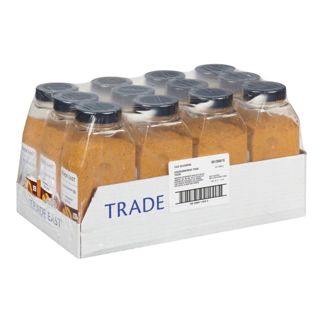 Trade East Assaisonnement pour tacos, 634 Grammes par Unité, Emballé dans une Caisse de 12 Unités. Ce Mélange Polyvalent d'Assaisonnements pour tacos Présente de l'Ail, des Poivrons et un Équilibre de Chaleur et de Douceur, Parfait pour la Nourriture Mexicaine et les tacos. l'Image Montre des Pots en Plastique Transparents avec Couvercles Noirs, Remplis d'Assaisonnement Orange-Brun, Disposés dans un Plateau en Carton Étiqueté « Trade East ».