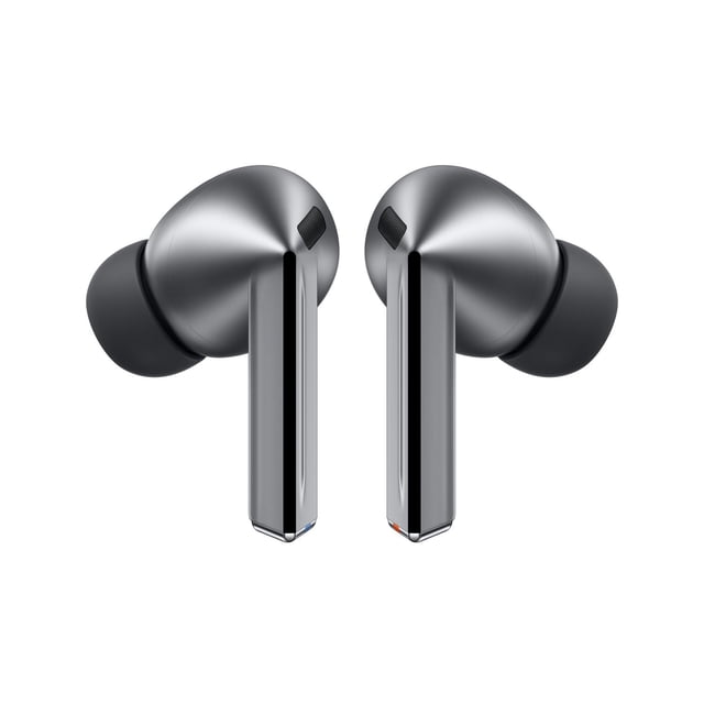 Samsung Galaxy Buds3 Pro true wireless earbuds in grey with a matte metallic finish and ergonomic silicone ear tips, featuring elongated stems with mesh speaker grilles, designed for adaptive noise adjustment and all-day comfort.
