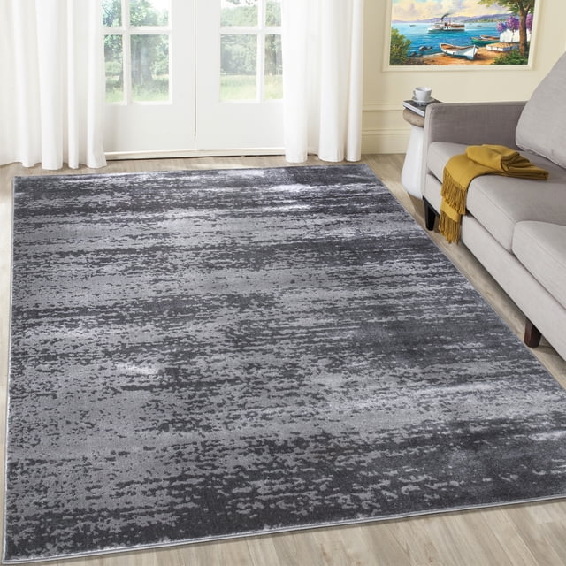 A2Z Palma 1787 Transitional Bohemian Office Kitchen Large Area Rug Carpet Tapis in dark grey, featuring an abstract pattern with intricate details, stripes, and spots. This modern, low-pile rug is ideal for living rooms, dining rooms, or offices. Displayed in a cozy living room with a sofa and natural light from large windows.