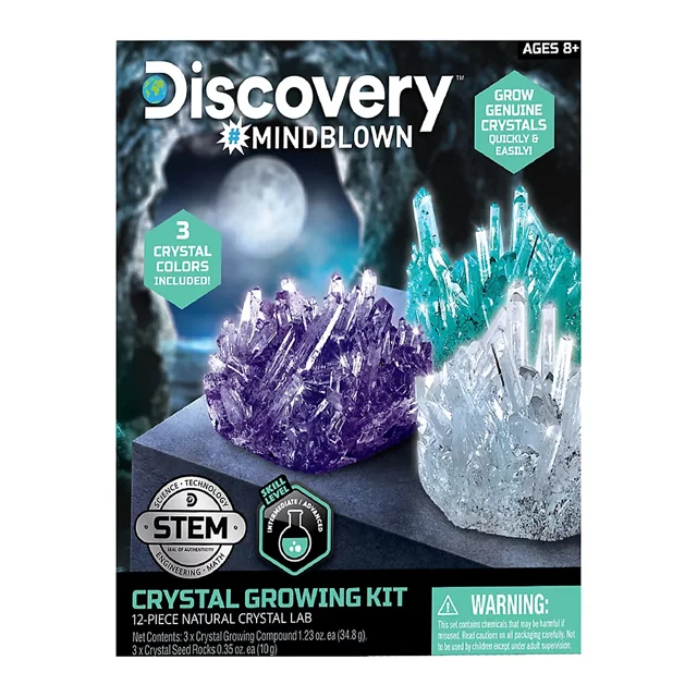 Discovery 12-Pc. Lab Crystal Growing Kit with three natural crystal formations in purple, teal, and clear colors on a dark platform against a moonlit cave background, perfect for STEM education and geology toys for ages 8 and up.