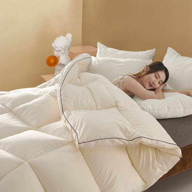 Cooling Comforter, Lightweight Queen Comforter, Down Alternative Bedding Comforters Queen Size, shown in a beige colour with a quilted design. The comforter is displayed on a bed with a person resting on it, highlighting its soft and cozy texture. Made of 98% cotton and 2% spandex, it is breathable and suitable for all seasons. The reversible design and machine-washable feature make it convenient for daily use.