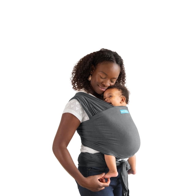 Moby Wrap Baby Carrier Element in dark grey feather-knit fabric worn front-facing with a baby, showing the adjustable one-size wrap tied securely around the waist and shoulders for ergonomic support, even weight distribution, and hands-free mobility.