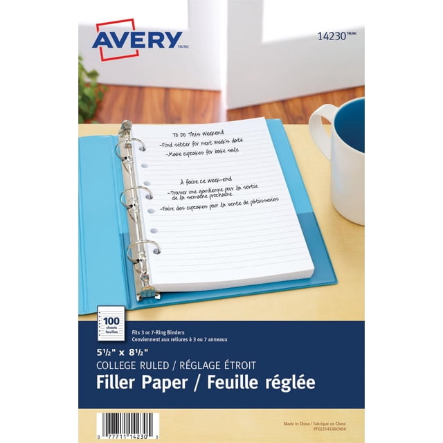 Avery Mini 5.5" x 8.5" Binder Filler Paper, 100 sheets of medium weight college-ruled paper pre-punched with seven holes to fit 3- or 7-ring mini binders, shown inside a blue binder on a light wood desk next to a white mug with blue interior, with handwritten notes in English and French on the top sheet.