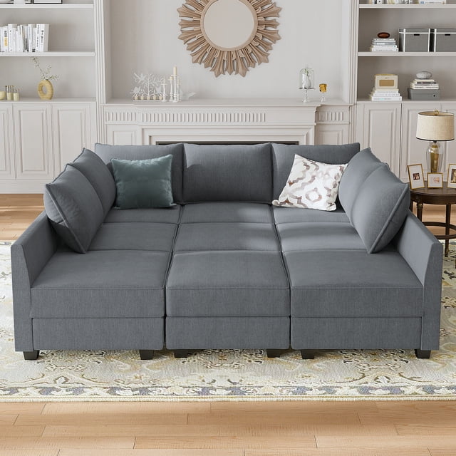 HONBAY Canapé Sectionnel Moderne en Lin, Canapé-Lit Modulaire pour Salon avec Rangement, Gris Bleuâtre. un Canapé Modulaire en Lin Gris Bleuâtre, Disposé en configuration en U, Idéal pour l'Assise du Salon. Comprend des Compartiments de Rangement sous Chaque Siège, des Coussins Amovibles et un design convertible Qui Se Transforme en Canapé-Lit de 81,5 Pouces par 87 Pouces. Positionné dans un Salon Lumineux avec des accents Décoratifs et un Tapis à Motifs.