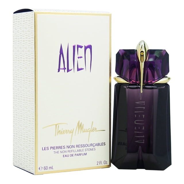 Alien by Thierry Mugler for Women - 2 oz EDP Spray (Refillable) displayed with its packaging. The bottle features a deep purple gem-like design with gold accents, showcasing its elegant and refillable nature. The packaging highlights the brand name and product details in purple and gold text. This oriental woody fragrance includes jasmine, cashmere woods, vanilla, and amber notes, ideal for daily use.