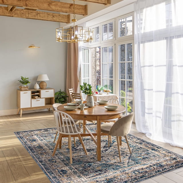 ECARPET Traditional Vintage Style Area Rug for Hallways, Bedroom and Living Room Bolivia Bijar Collection under a round wooden dining table with four chairs in a bright room with large glass windows, wooden ceiling beams, and light hardwood floors, showing the rug's vintage pattern and soft, durable texture ideal for accenting living spaces and hallways.