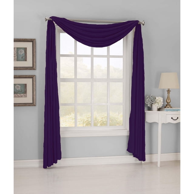 Sun Textile Hampton Microfiber Scarf in eggplant purple polyester fabric with rod pocket, draped over a silver curtain rod on a white window frame in a light grey room with a white side table, lamp, flowers, and framed floral artwork, ideal for decorative window treatment.