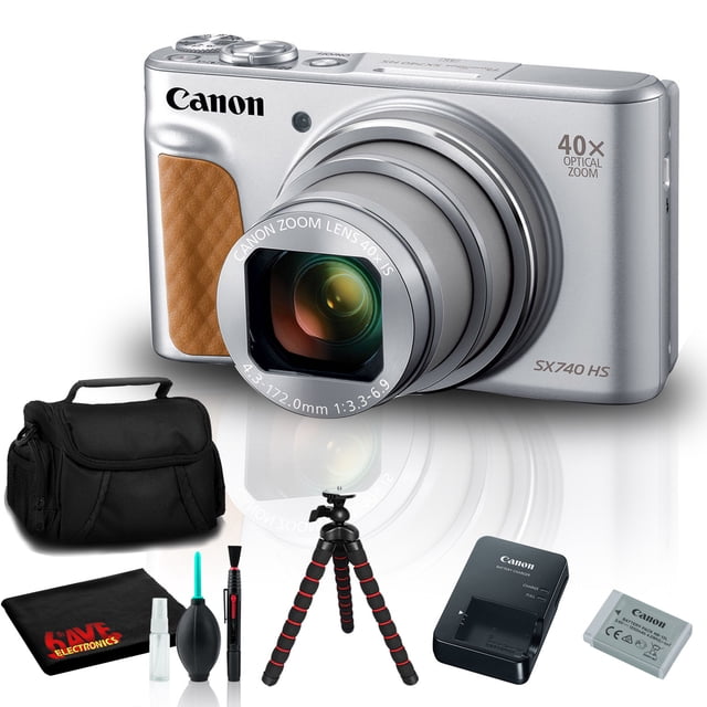 Canon PowerShot SX740 HS Digital Camera in silver with a 40x optical zoom lens, shown alongside included accessories: a small camera case, 12-inch flexible tabletop tripod, Canon NB-13L lithium-ion battery pack, Canon CB-2LH battery charger, WS-800 wrist strap, microfiber cloth, and lens cleaning kit. The camera features a 20.3MP CMOS sensor, 4K video recording, a 3.0-inch tilting LCD screen, and built-in Wi-Fi and Bluetooth for easy sharing.