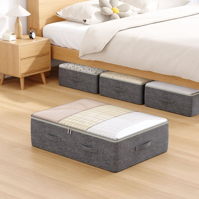 Underbed Storage Bag for household clothes and quilts, featuring a large foldable design measuring 18.5 x 10.63 x 7.87 inches. Made of durable cationic fabric with reinforced steel frame and medium-density fiberboard base for stability. The bag is shown in a bedroom setting, placed under a wooden bed alongside other similar storage bags. It has a zippered top and side handles for easy access and portability. Ideal for space-saving and closet organization.
