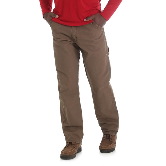 Rustler Men's Carpenter Jean in brown 100% cotton canvas with straight leg and loose fit, featuring front slash pockets, round back pockets, hammer loop, belt loops, and ruler pocket, styled with brown work boots and a red long-sleeve shirt on a white background, suitable for durable workwear needs.