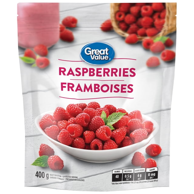 Great Value Frozen Raspberries 400g package showing a white bowl filled with frozen red raspberries garnished with green leaves on a light wooden surface, with scattered raspberries and a wicker basket in the background, no added sugar, often used in smoothies or desserts.