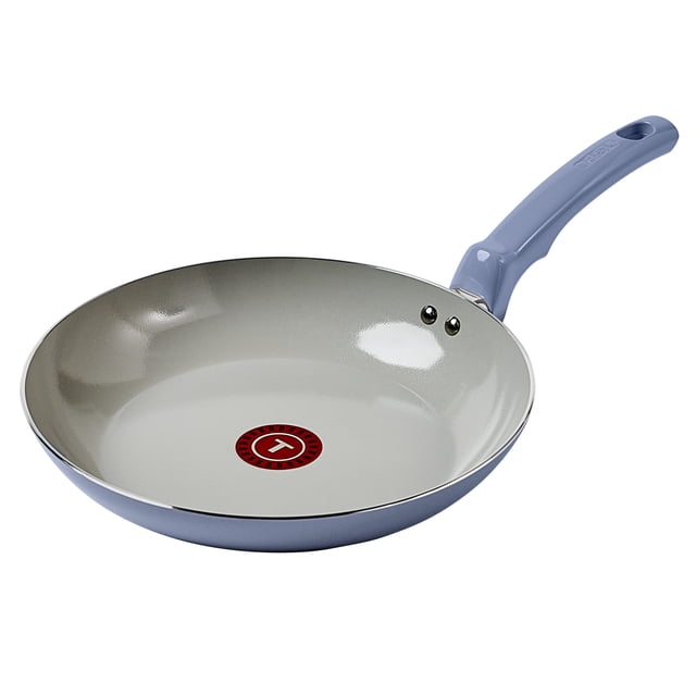 T-fal Ceramic Essential frying pan with ceramic nonstick interior and light blue recycled aluminum exterior, featuring a red Thermo-Spot heat indicator, ergonomic stay-cool handle, and riveted handle attachment, designed for even heat distribution and compatible with all cooktops except induction, ideal for healthy cooking with little oil.