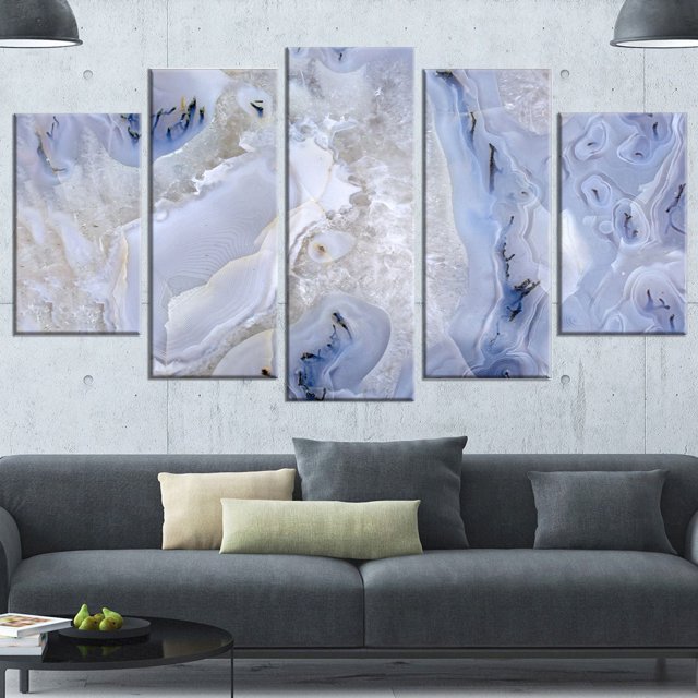 Design Art Agate Stone Background Abstract Canvas Wall Art Print featuring a five-panel gallery wrapped canvas with blue and gray agate stone patterns, displayed above a modern gray sofa with neutral cushions in a minimalist living room with concrete walls and pendant lights.