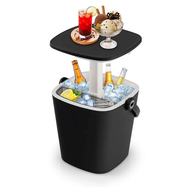 Costway 4 Gallon Portable Cooler Bar Table in black with a lift-top lid, integrated bottle opener, and detachable storage rack. The image shows the cooler filled with ice, bottles, and lemon slices, with the tabletop raised to display drinks and desserts. Made of weatherproof PP material, it functions as a side table, cocktail table, or ice cooler, ideal for outdoor activities like camping and picnics.