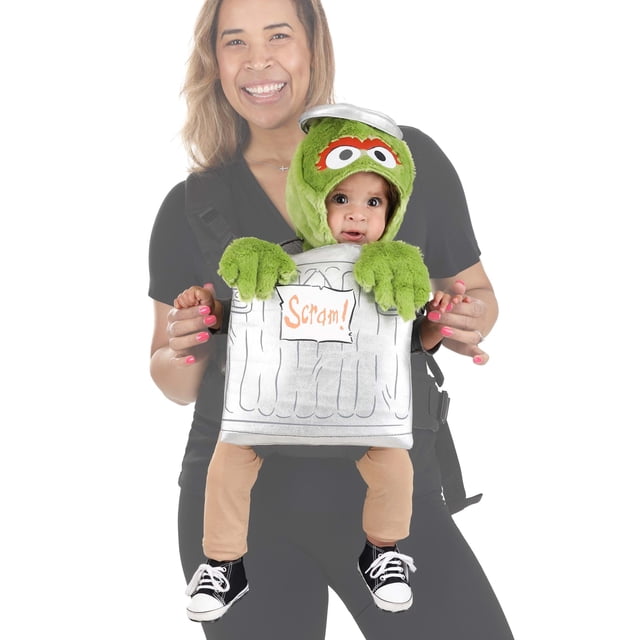 Sesame Street Oscar Baby Carrier Cover front-facing centered view of a polyester stuffed carrier cover panel with green faux-fur hood, embroidered and appliqued eyes and eyebrows, foam metallic-silver trash-can lid hat, printed Oscar graphics on metallic-coated panel, stuffed faux-fur hands on top edge, elastic and hook-and-loop straps that attach through carrier leg openings and chin strap fastener; brand FUN Costumes, carrier not included, suitable for character-themed baby photos.