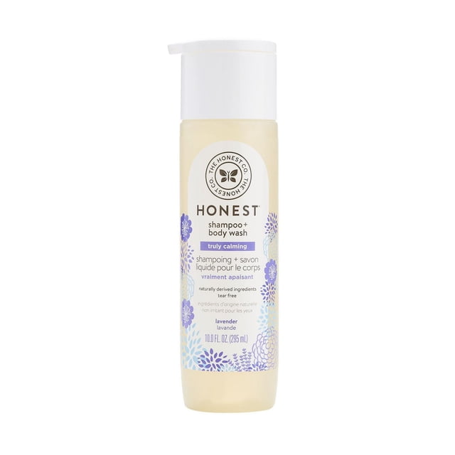 The Honest Company Shampoo & Body Wash - Truly Calming Lavender in a 295 ml translucent bottle with white pump and purple floral accents, featuring bilingual text and tear-free formula with naturally derived ingredients for gentle 2-in-1 hair and body cleansing.