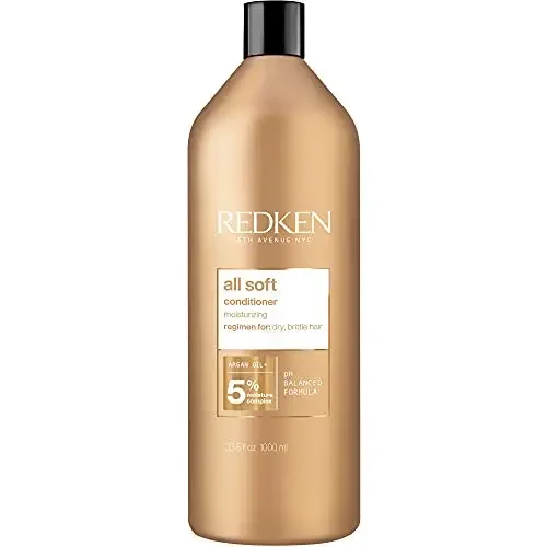 All Soft Conditioner-NP by Redken for Unisex - 33.8 oz Conditioner. A large, gold-toned bottle with a pump dispenser, featuring Redken branding and product details. Designed to detangle, condition, and soften dry, brittle hair with 15x more conditioning when used with the complete All Soft system. Suitable for unisex use.