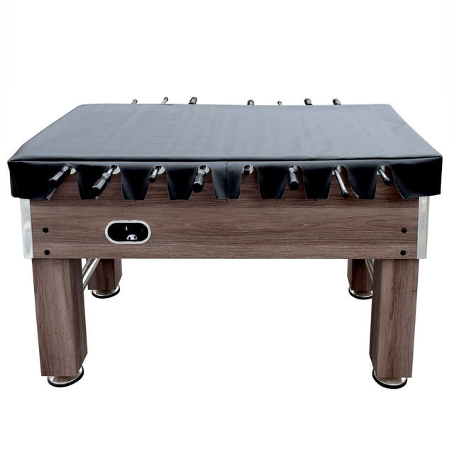 Hathaway 54" Foosball Table Cover in black rip-resistant synthetic leatherette with scalloped edges, fitted over a wooden foosball table with metal rods visible, designed to protect and keep the table clean when not in use.